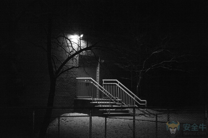 Illuminated back door and stairs in the dark of night.
